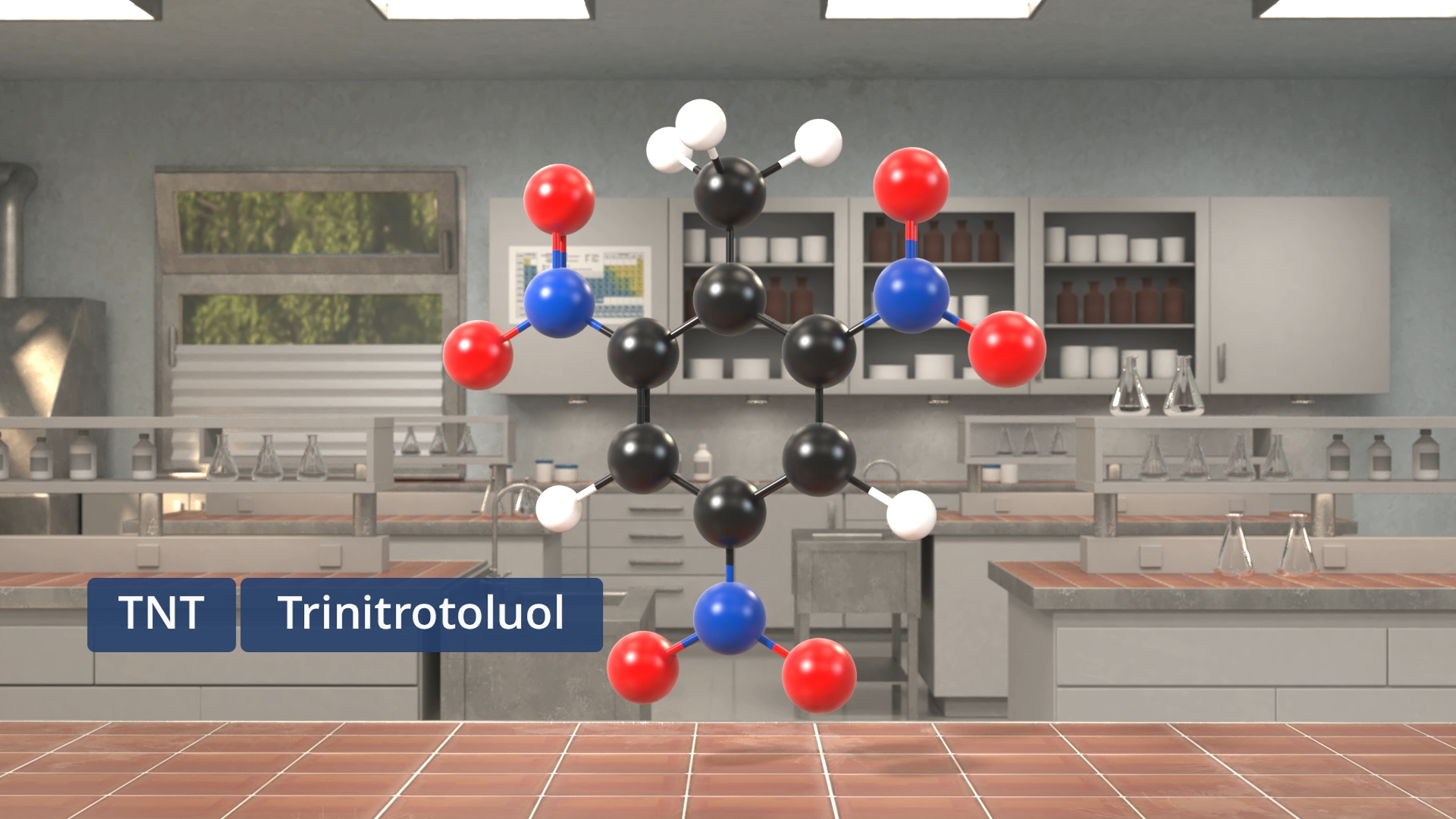 Molekülmodell von Trinitrotoluol (TNT) mit farbigen Kugeln für Atome in einem Laborraum.