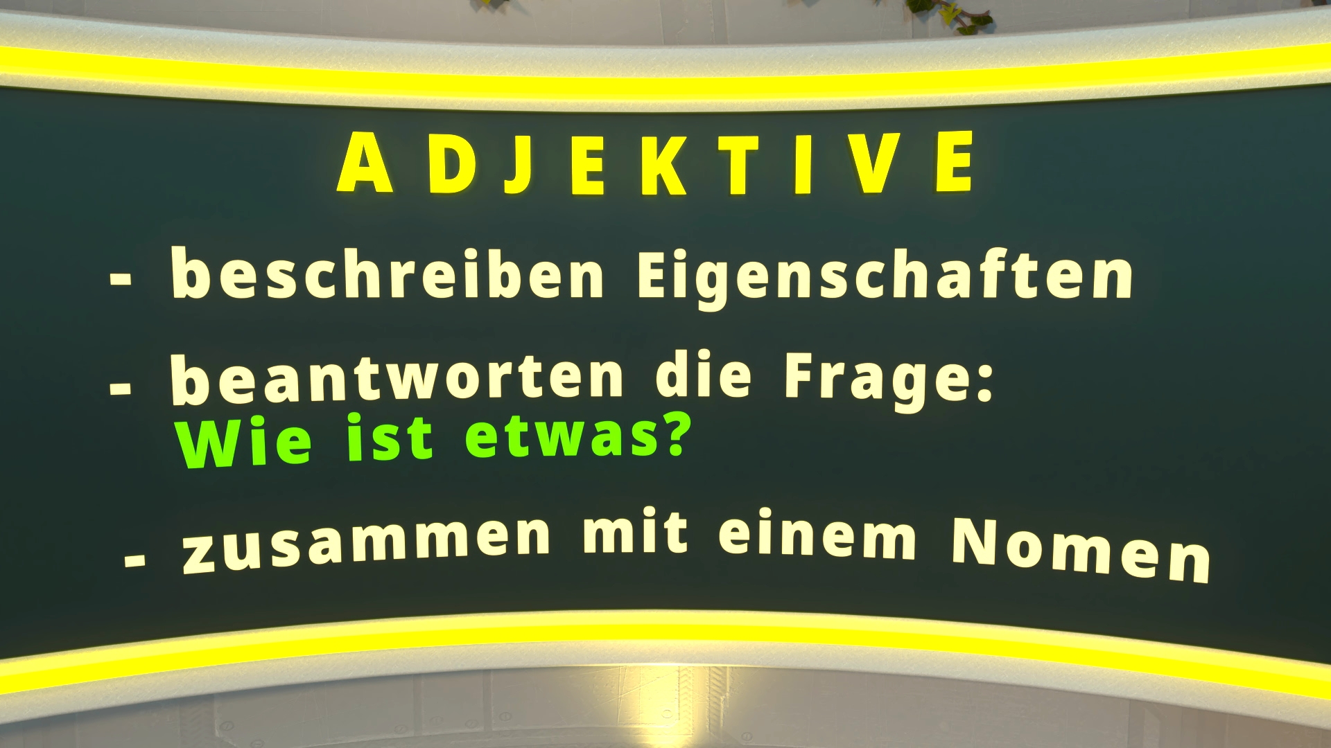 Gelb-grüne Textfolie mit der Überschrift 'ADJEKTIVE' und den Stichpunkten '- beschreiben Eigenschaften', '- beantworten die Frage: Wie ist etwas?', '- zusammen mit einem Nomen'