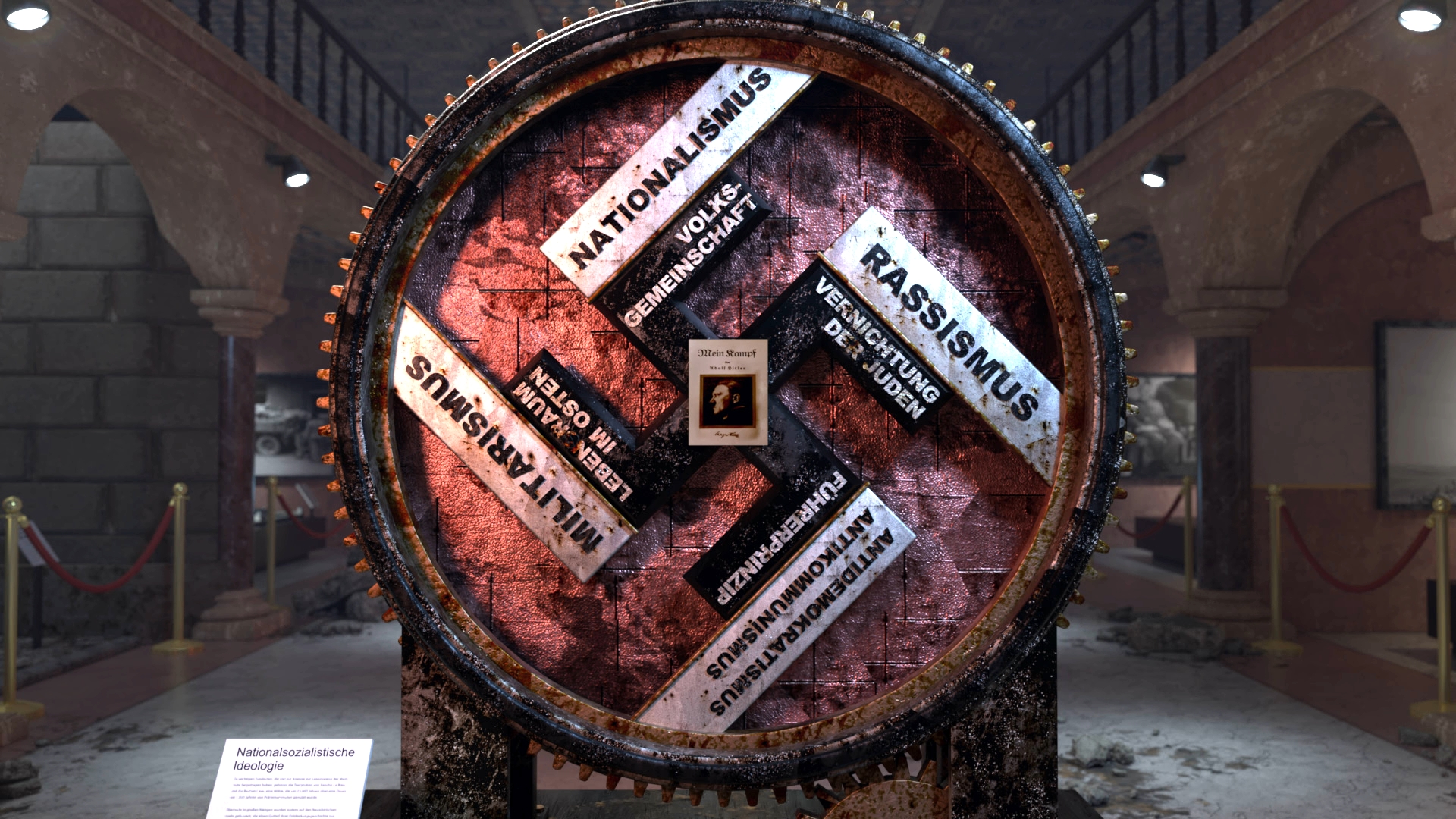 Ein großes Rad mit den Begriffen 'Nationalismus', 'Rassismus', 'Militarismus' und 'Kolonialismus' auf den Segmenten, in einem Ausstellungsraum.