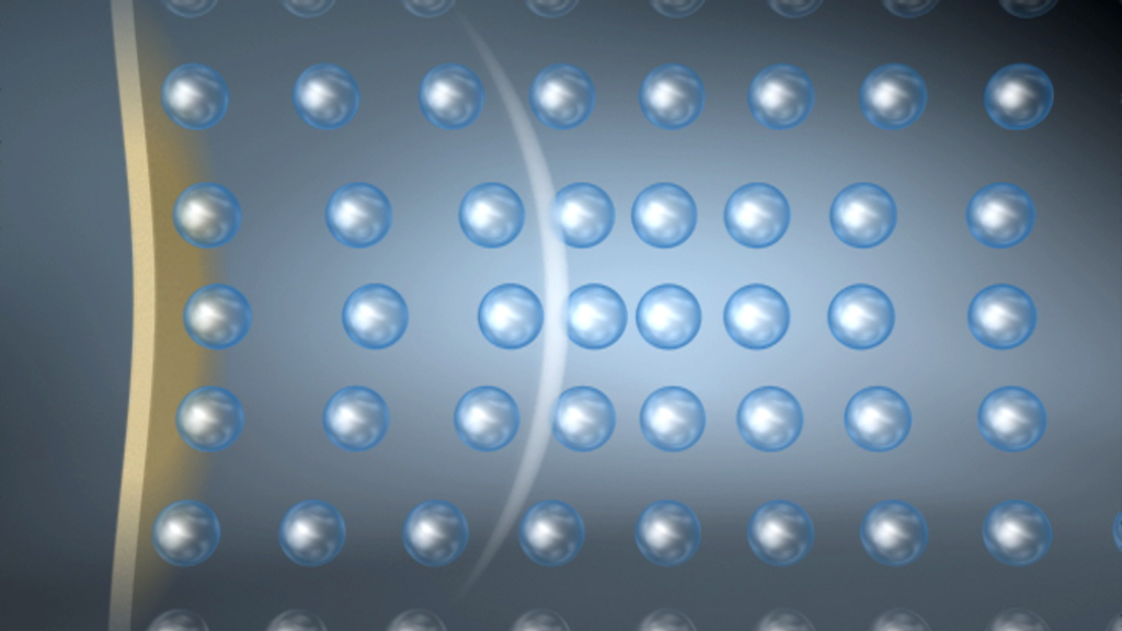 Grafik mit einer Anordnung von blauen Kugeln auf einem grauen Hintergrund, die in einem regelmäßigen Muster angeordnet sind.