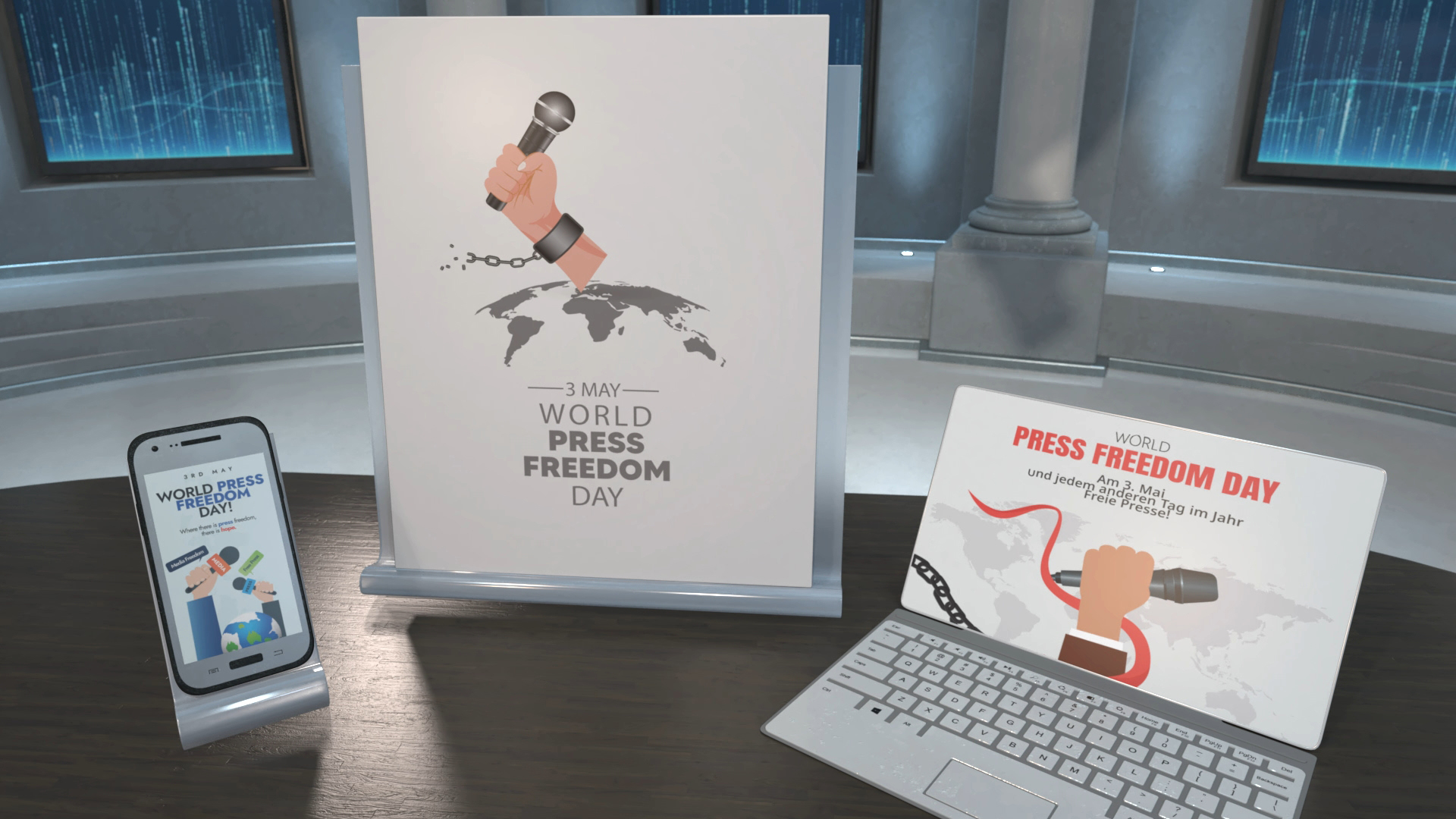 Plakat mit einer Hand, die ein Mikrofon hält, über einer Weltkarte, Text '3 May World Press Freedom Day'; Laptop mit ähnlichem Motiv und Text 'World Press Freedom Day und jeden Tag im Jahr'; Smartphone zeigt Grafik zum Welttag der Pressefreiheit.