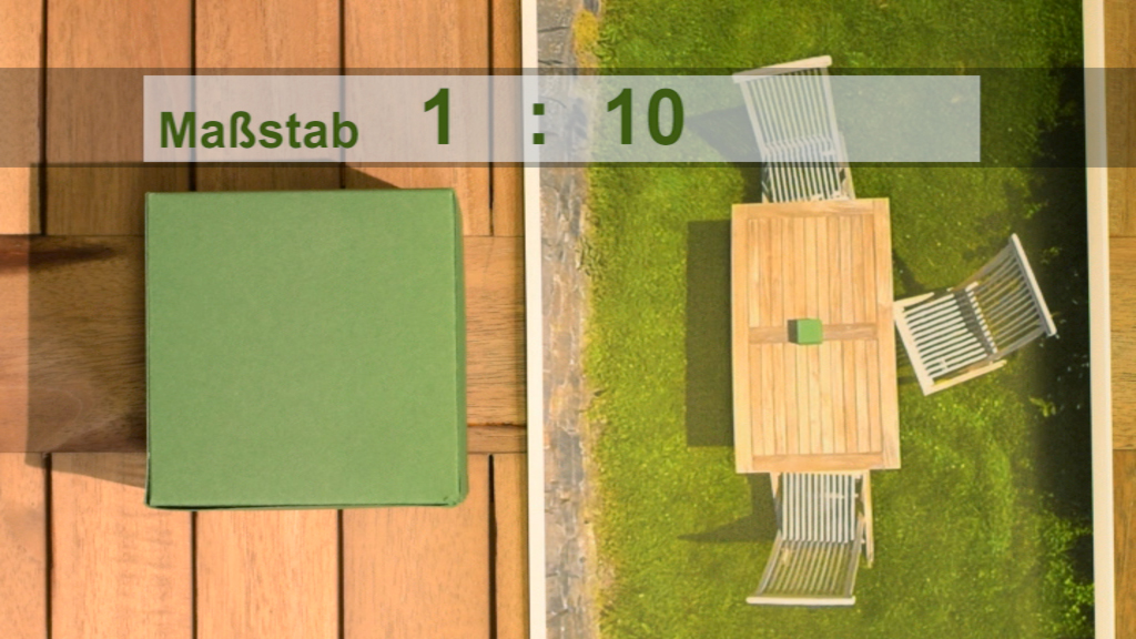 Eine Draufsicht auf einen Tisch und Stühle im Maßstab 1:10, mit einem grünen Quadrat auf dem Tisch.