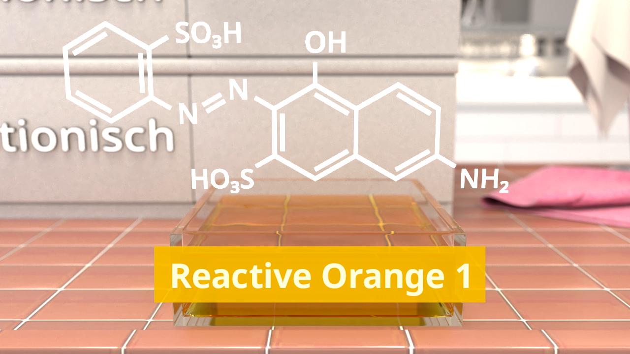 Chemische Strukturformeln von Reactive Orange 1 auf einem Tisch, mit einer gelben Probe im Vordergrund.