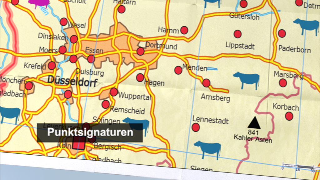 Karte von Nordrhein-Westfalen mit Städten und Punkt-Signaturen, darunter Kühe und Berge, sowie der Hinweis auf 'Punktsignaturen'.